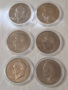 4 - Bicentennial Eisenhower Dollars and 2 - 1973 Eisenhower Dollars .