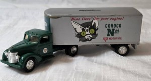 ERTL-Die-Cast metal coin bank featuring a green 1948 Ford Tractor and a silver Conoco trailer. (9 L x 3 H x 2W)-- VERY COLLECTIBLE