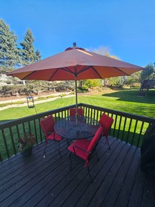 Outdoor Mesh Patio Dining Set with Four Cushioned Chairs and Umbrella