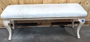 White wooden bench with cushion