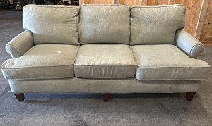 Green 3 seat couch and green cloth armchair with ottoman