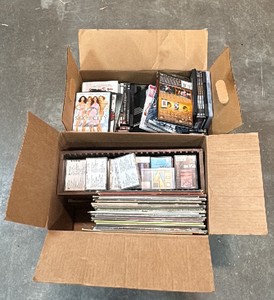Boxes of movies, dvds, cassettes, and vynls
