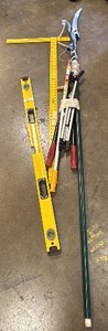 Yard tools, yellow meter stick, yellow level