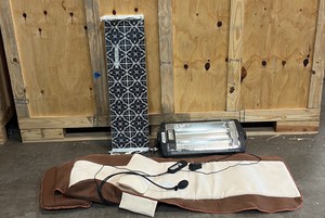Comfort zone heater, black and white shelf, Comrelabody massage mat with heat, vibration motors, an attached hand controller, and a support pillow