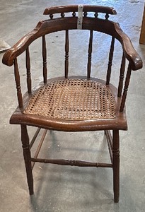 Dark brown wooden chair with wicker seat