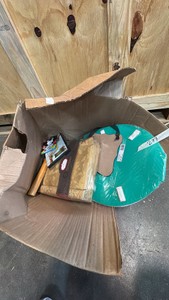 Broken box of painting supplies, bed sheet set, hammer, movie, toilet seat