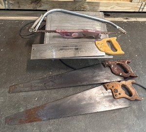 4 hand saws and 1 portable table saw