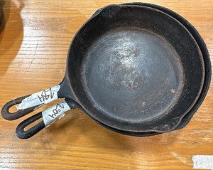 Stacked pair of vintage cast iron skillets
