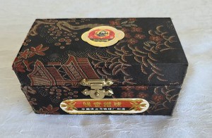 Pair of green Chinese Baoding Exercise and Stress Balls with Floral Bird Design in Black Fabric Presentation Box with Directions.  The Stress Balls make a soft chiming sound when used.