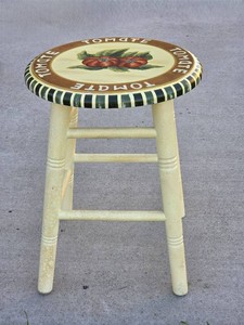 Wooden Country Farmhouse style small stool featuring a round top with a tomato illustration and the word TOMATE written around the border. 18 12 T x 14 W