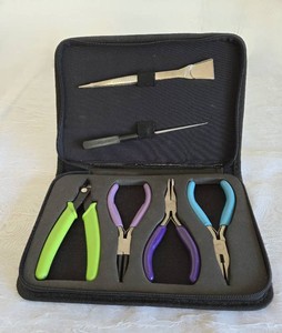 Black case with Jewelry Making Tools inside. Case zipper is broke.