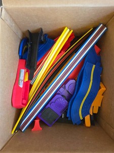 Vintage 100 Piece mixed lot of toy car track pieces, including colorful flexible Hot Wheels style straight strips, blue curved plastic segments.