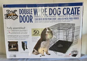 Pre-owned.  Double Door Wire Dog Crate.  For medium-size dogs up to 50 lbs.