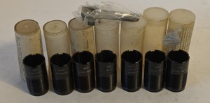 Browning threaded choke tubes marked for modified, improved cylinder, lead shot and steel shot applications, with plastic storage tubes and choke wrench.