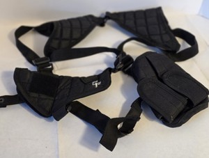 Black leather shoulder holster setup with adjustable harness straps, dual snap-closure magazine pouches, and a separate belt-clip holster.