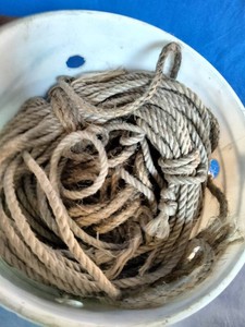 Natural fiber rope coiled up inside a white bucket