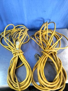 Two yellow, heavy-duty or general-purpose outdoorindoor 3-prong extension power cords