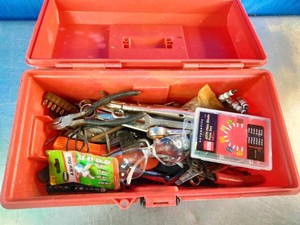Plastic toolbox filled with various hand tools,