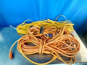 Heavy-duty orange and yellow electrical extension cords.