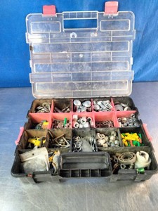 Plastic small parts organizer box with a clear lid filled with various types of hardware