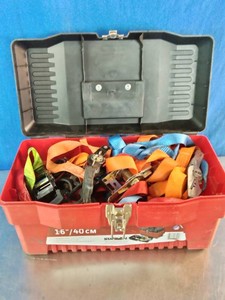 Plastic portable tool box filled with a collection of tie-down ratchets straps