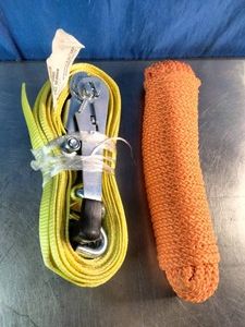 Yellow ratchet tie-down strap (left) and a coiled orange braided tow or utility rope