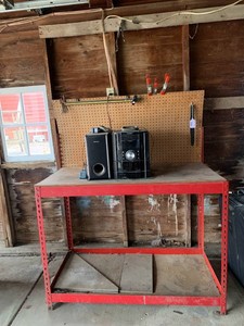 Metal work bench with pegboard and clamps