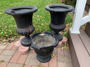 Black plasticresin planters, round patio bricks
