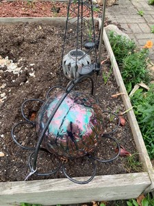 Gazing ball, metal daisy bracketbasket, other garden pieces