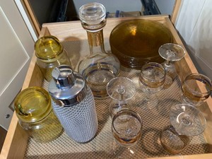 Decanter, stemware, amber plates all on shelf