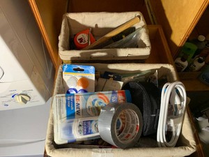 Household repair supplies, lights, iron all on 2 shelves