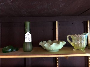 Green glassware, Vaseline glassware all on shelf