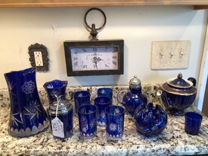 Cobalt blue items, clock some cut glass all on shelf