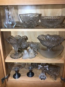 Clear glassware, some sterling and cut glass all on 3 shelves