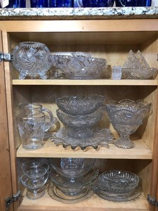 Clear and cut glassware all on 3 shelves