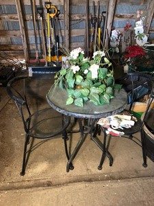 Metal patio table and chairs, artificial flower arrangement
