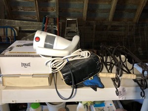 Sony radio, metal wine rack, Black and Decker steamer, massage gun all on top shelf