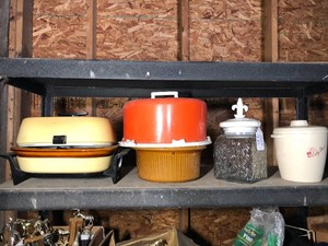 Crock pots, plastic cake carrier and more all on shelf
