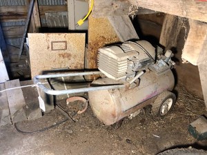 Air compressor, wood work bench, wood blockings items on floor