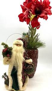 Santa Figure with Amaryllis Floral Arrangement in Decorative Vase
