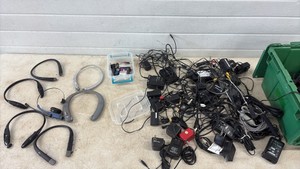 Assorted power adapters and wireless headphones